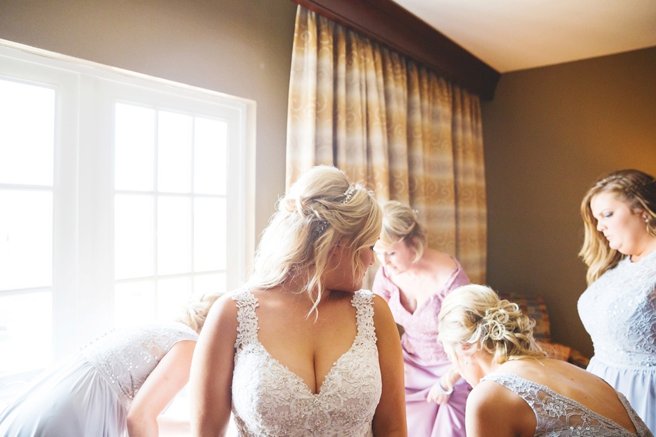 Bloomington Illinois Summer Wedding Photography, bride getting into dress for wedding