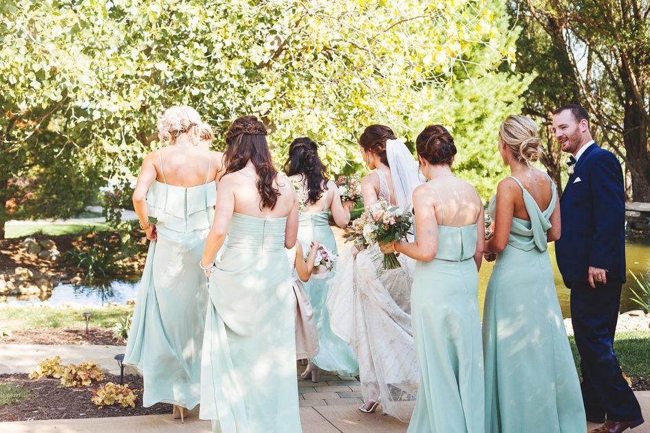 bridesmaids walking to wedding day ceremony by Rachael Schirano Photography