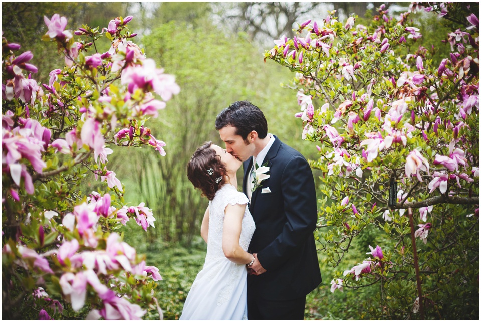 bloomington wedding photography, Bride and groom kiss in the gardens at Morton Arboretum on wedding day.