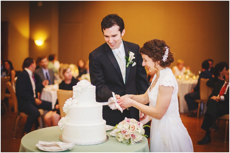 bloomington wedding photography, Bride and groom cut the cake at Thornhill Education Center wedding reception.