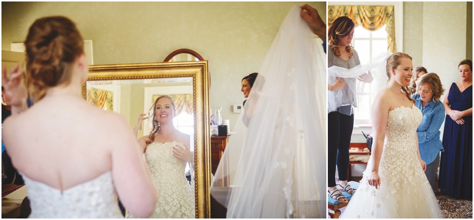 Bride in mirror as her veil is put in her hair.