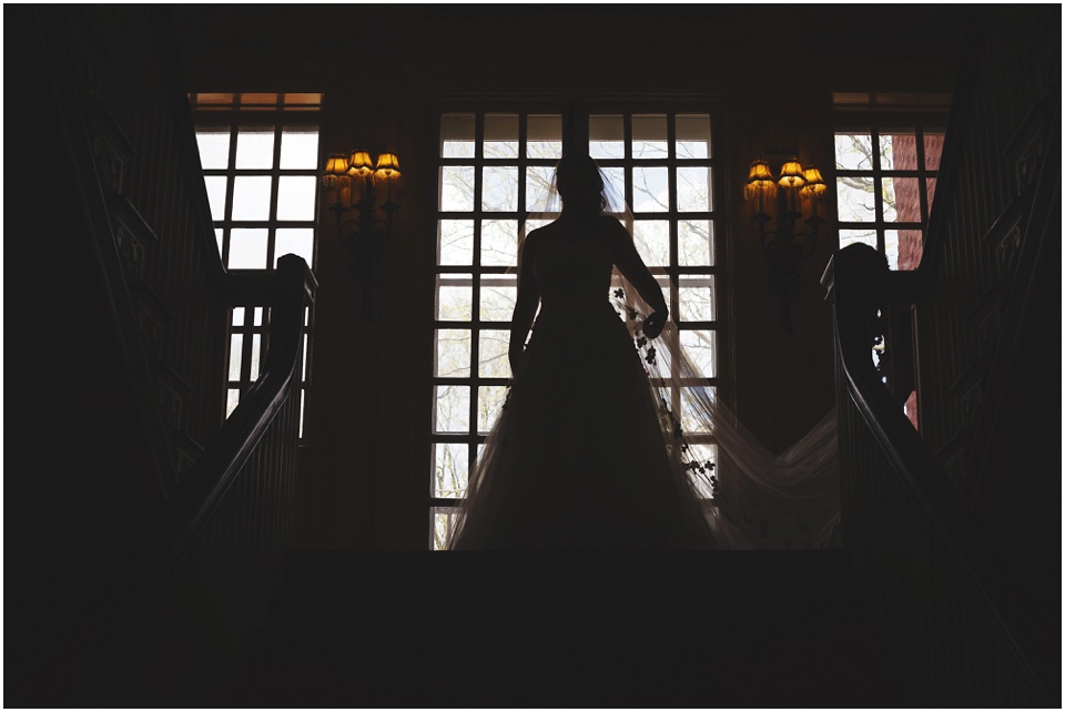 Silhouette of bride in window.