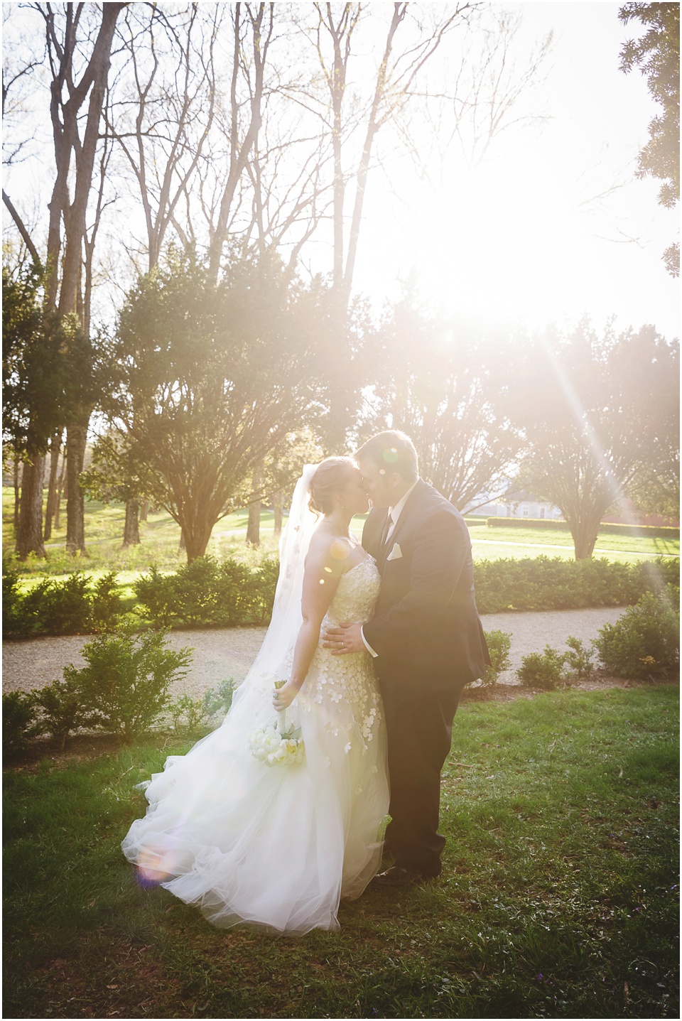 Backlit sunflare of bride and groom at Allerton Park Wedding.
