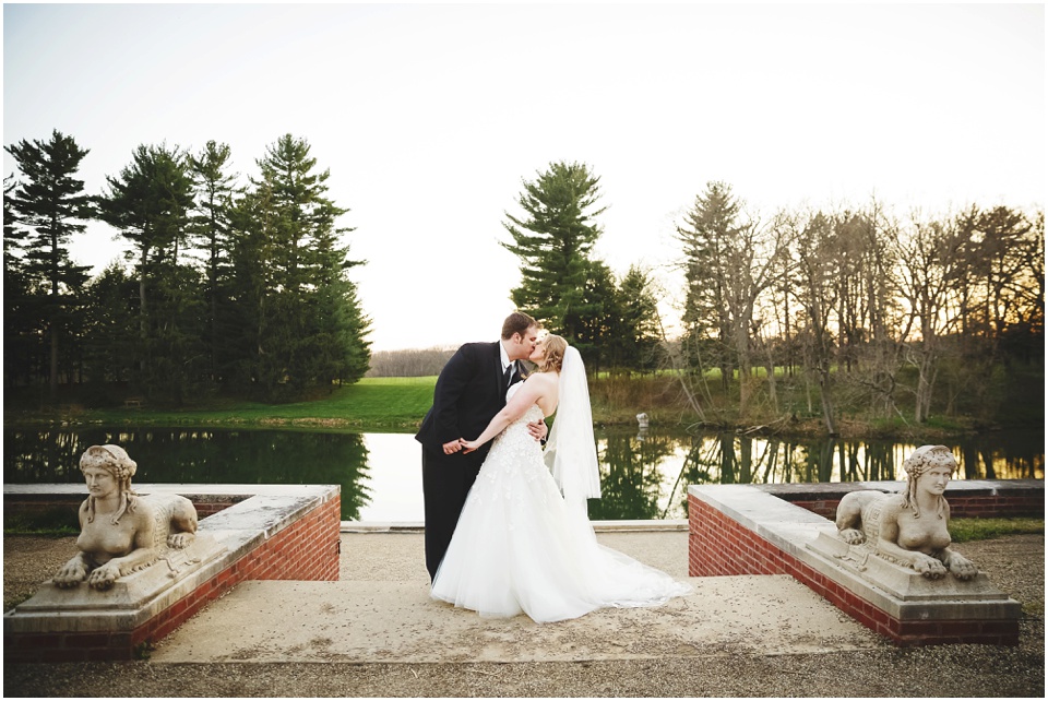 Bride and Groom kiss at the lake at Allerton Park Mansion.