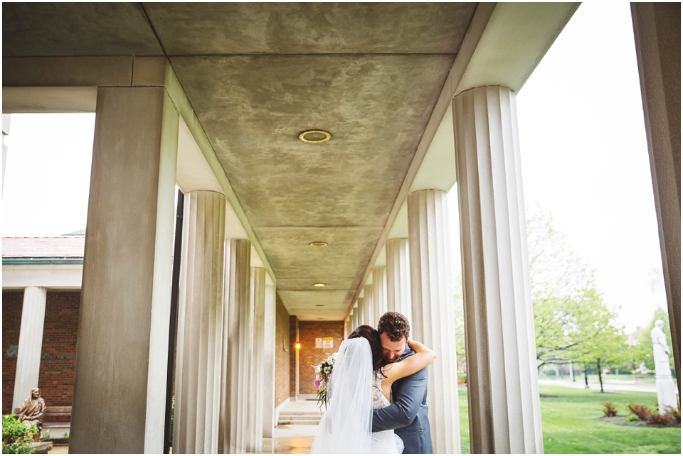 cathedral wedding photography, Bride and groom hugging during rainy day wedding portraits.