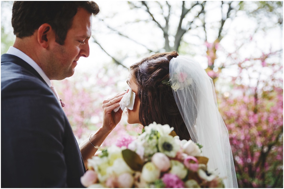 cathedral wedding photography, Bride wipes away tear after seeing groom for the first time.