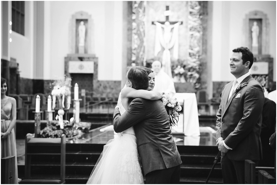 cathedral wedding photography, Bride hugs father at the alter.