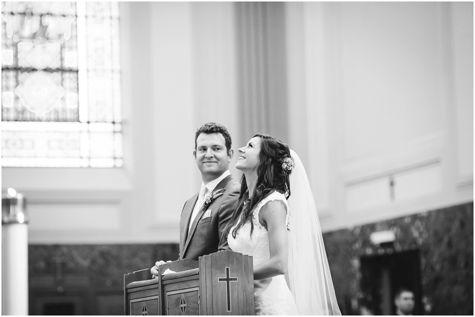 cathedral wedding photography, Bride laughs at the altar.
