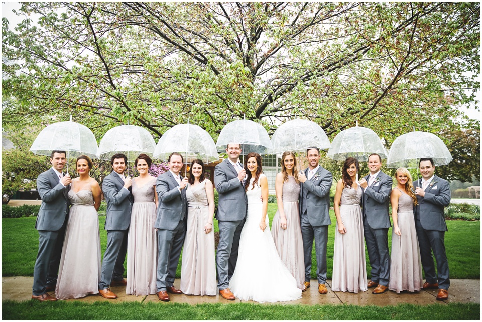 cathedral wedding photography, Wedding Party with umbrellas on a rainy wedding day.