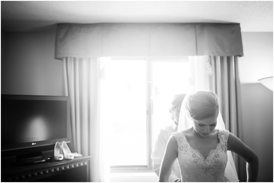 Bride getting into wedding dress by Central Illinois Wedding Photographer Rachael Schirano