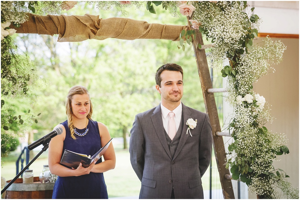 Groom sees bride at ceremony at Kickapoo Creek Winery Pavillion Wedding Ceremony by Wedding Photographer Rachael Schirano