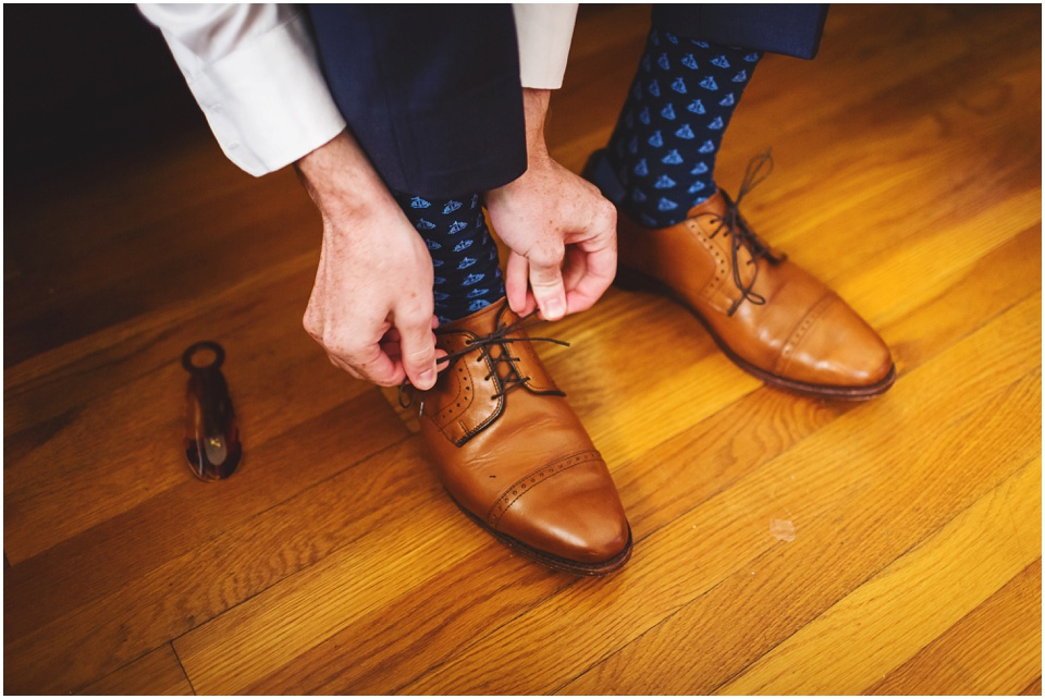 Navy blue groom suit with navy blue patterned socks and brown shoes