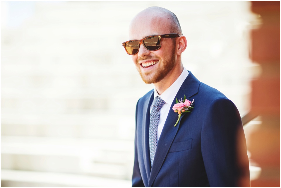 Groom with navy blue suit in sunglasses