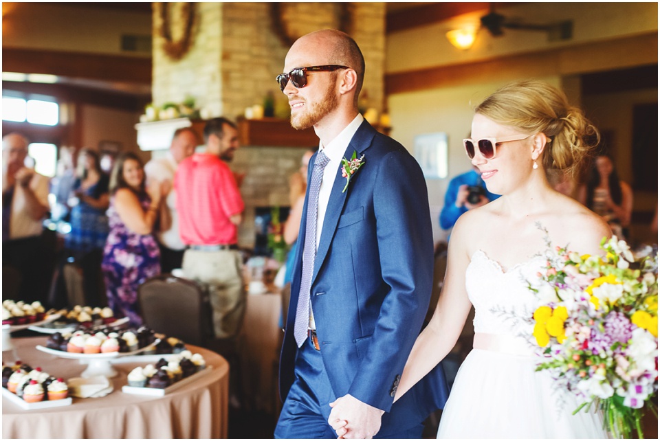 Bride and groom announced into reception wearing sunglasses