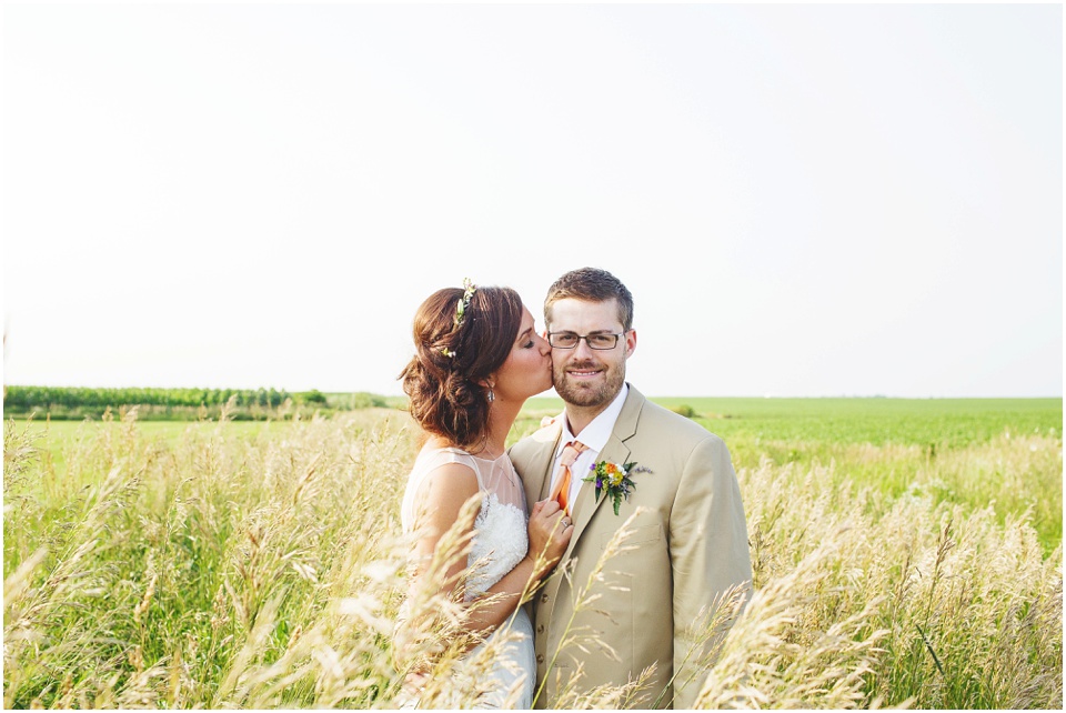 pear tree estates wedding photography, Bride and groom kissing in an open field.