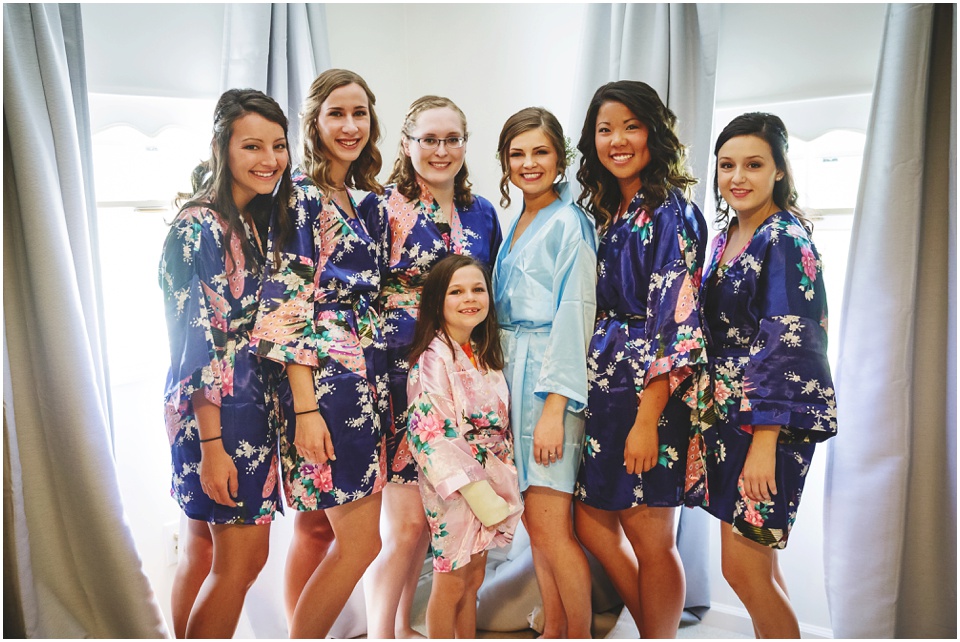 Bride and bridesmaids in floral robes.