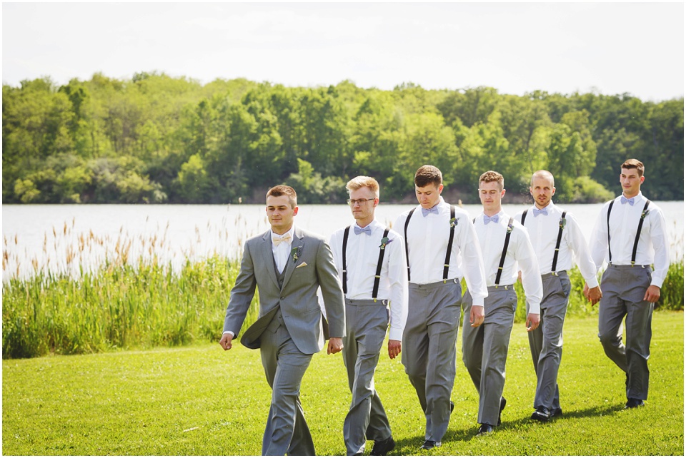 outdoor Illinois wedding photographer, Groom and groomsmen walk into ceremony at Comlara Park in Hudson, IL.
