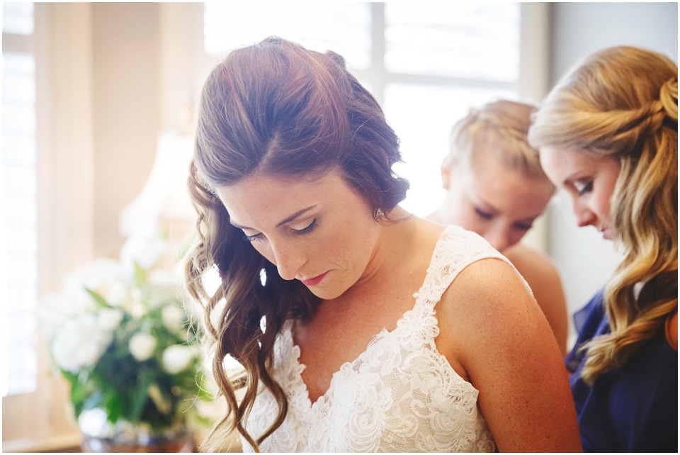 bride getting into wedding gown by Chicago Wedding Photographer Rachael Schirano
