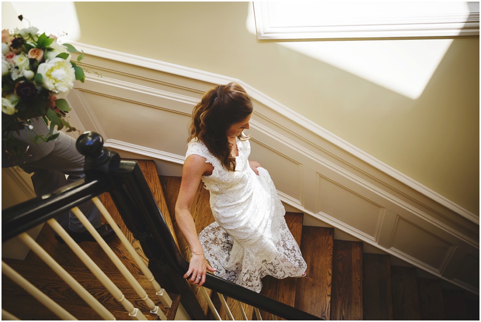 modern Chicago city wedding photography, bride and groom walking down stairs at home by Chicago Wedding Photographer Rachael Schirano