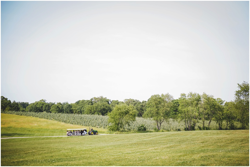 outdoor wedding photography, Wedding party rides golf cart to wedding ceremony by Bloomington Illinois Wedding Photographer Rachael Schirano