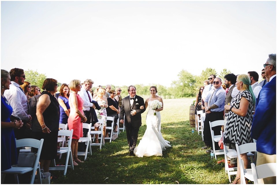 outdoor wedding photography, Father and daughter bride walking down the aisle at a country wedding by Bloomington Illinois Wedding Photographer Rachael Schirano