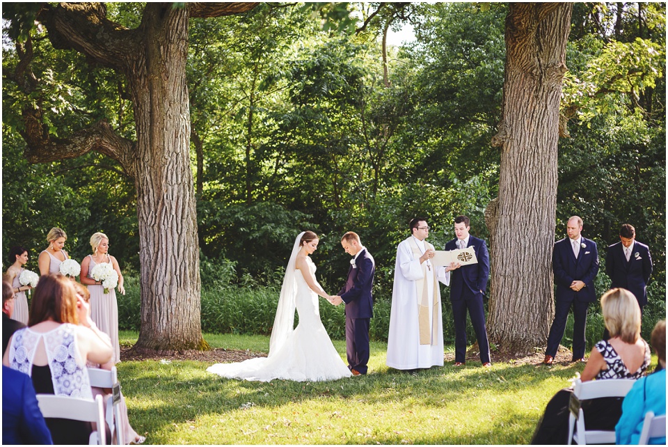 outdoor wedding photography, Bride and groom pray at country field wedding ceremony by Bloomington Illinois Wedding Photographer Rachael Schirano