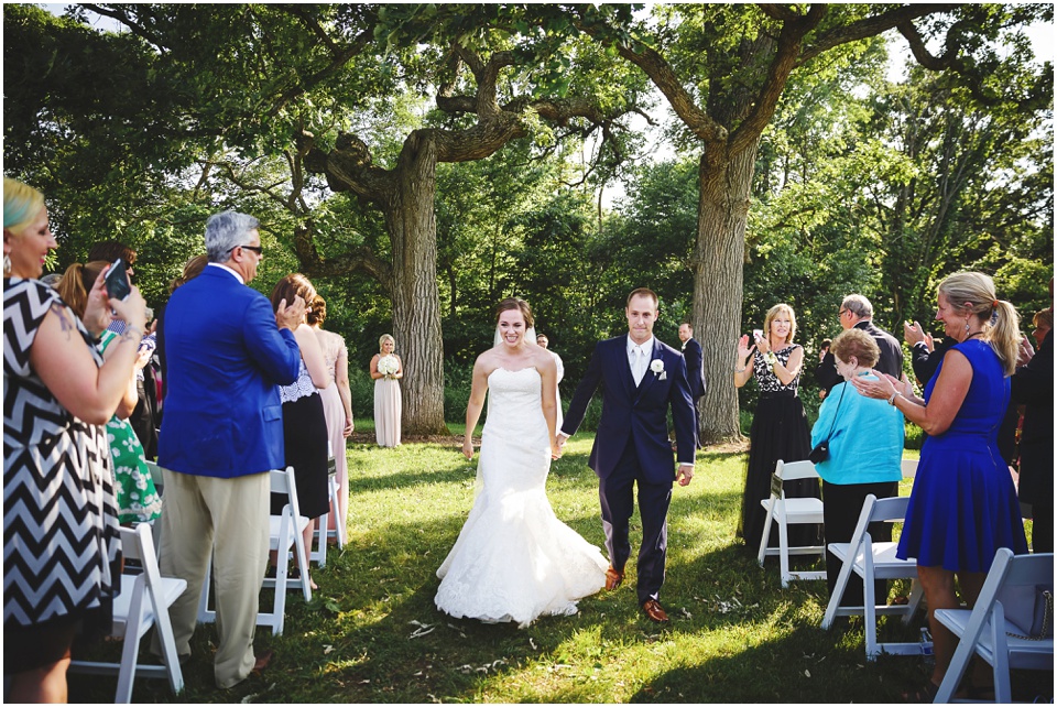 outdoor wedding photography, Bride and groom recess down the aisle by Bloomington Illinois Wedding Photographer Rachael Schirano