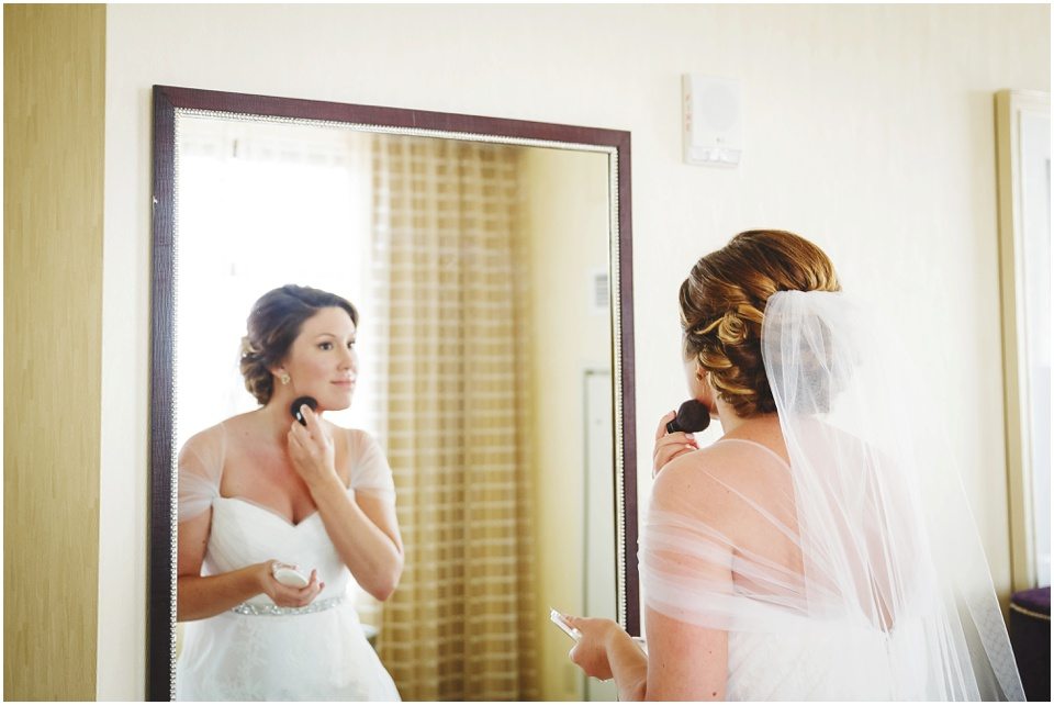 central illinois wedding photographer, Mother helping bride get ready on wedding day at Bloomington Illinois Hotel