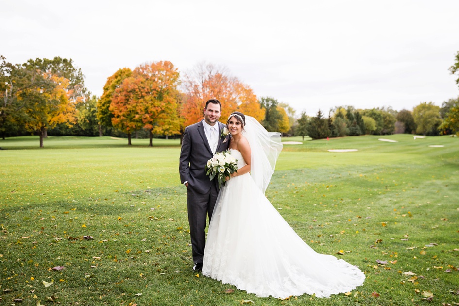Bride and groom portraits in field during fall wedding