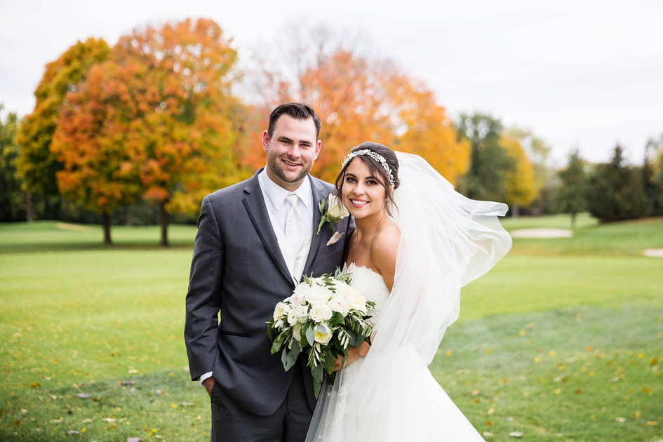 Bride and groom portraits in field during fall wedding