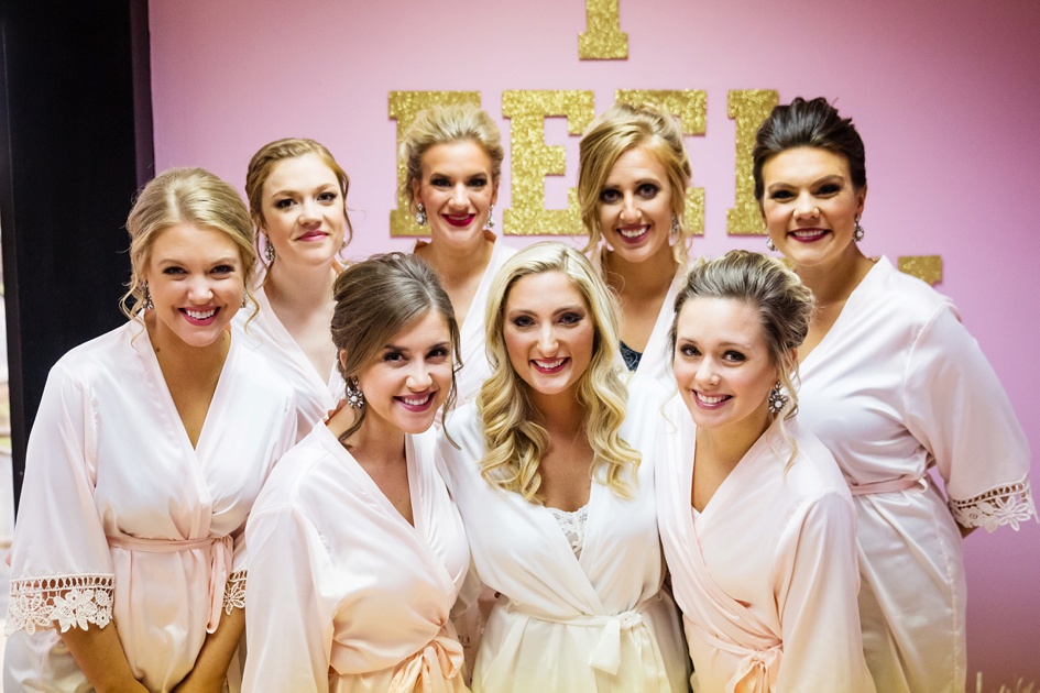 Pink and gold bridal party in robes.