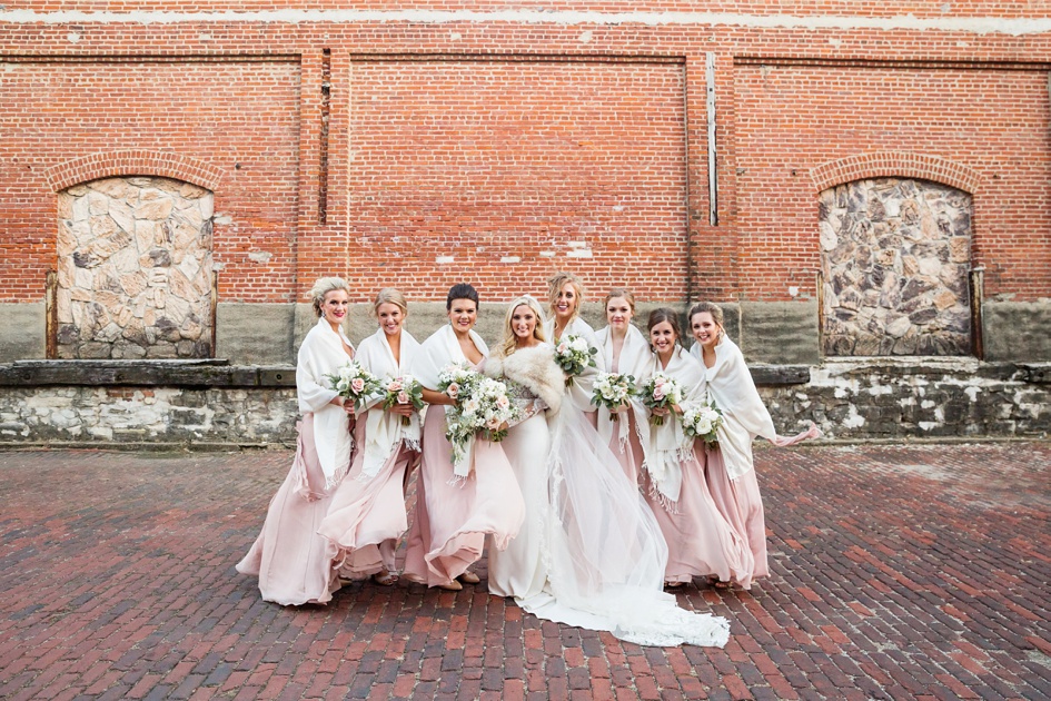 black and blush color winter bridal party photos with fur