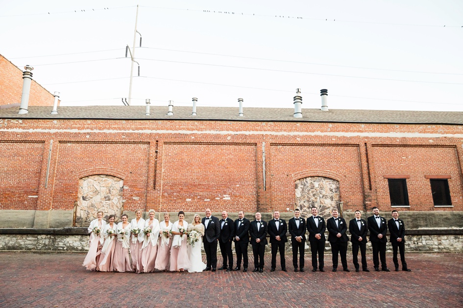 black and blush color industrial winter bridal party photos with fur