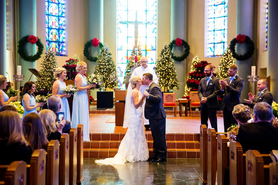 christmas themed church wedding ceremony first kiss