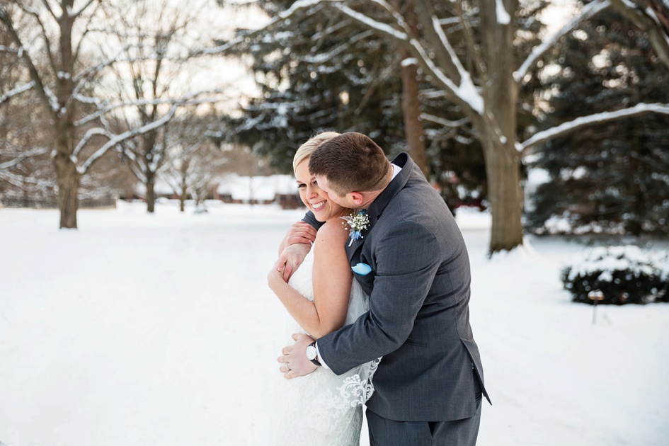 bride and groom portraits in snowy winter wedding 