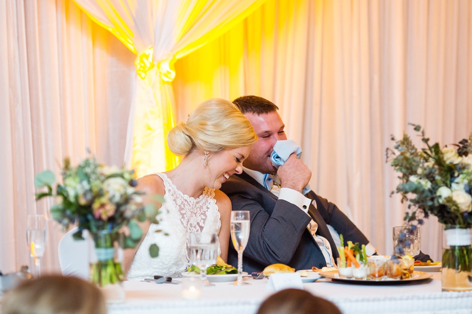 bride and groom toasts laughing