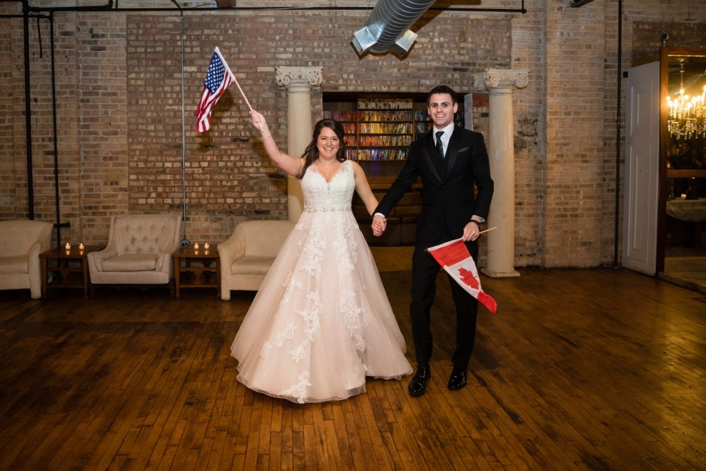 Bloomington IL wedding photographer, Central Illinois wedding photographer, Peoria IL wedding photographer, Champaign IL wedding photographer, indoor wedding, black and green wedding colors, vintage inspired wedding, emerald green wedding, bride and groom holding USA and Canada flags